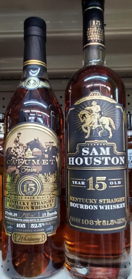 Bourbon and whiskey bottles arranged on shelves